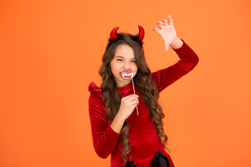 Halloween costumes. Photo booth props. Vampire teeth. Little girl cute small horns celebrate Halloween. Carnival concept. Small child imp style accessory. Halloween party. Trick or treat concept