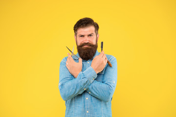 Fresh hairstyle. Barbershop concept. Barbershop salon. Personal stylist. Vintage barber. Bearded man hold razor and scissors. Classic values. Retro barbershop. Hipster with tools. Designing haircut
