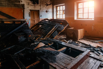 Burned school classroom, desk in black soot
