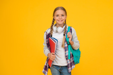 Fototapeta Motivated and diligent. Stylish schoolgirl. Girl little fashionable schoolgirl carry backpack. Schoolgirl daily life. School club. Modern education. Private schooling. Teen with backpack and books obraz