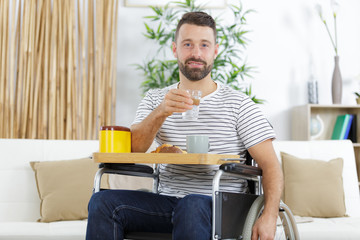 positive delighted invalid man having breakfast