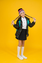 Long and braided. Adorable little child smile with long blond hair braids on yellow background. Happy small girl with long hairstyle in autumn style. Styling long hair for school time