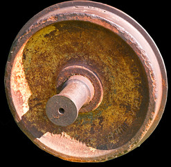 The wheel covered with rust from the car of the old railway