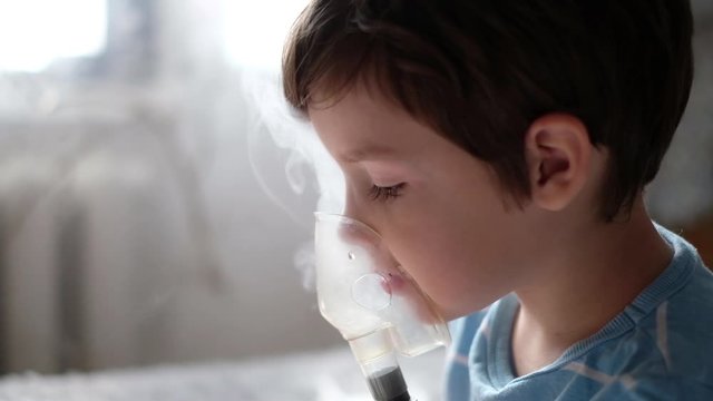 sick child breathes in a nebulizer