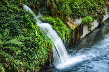 Fototapeta na wymiar small waterfall on canal
