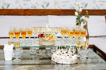 Wedding decor. Serving buffet table. Champagne glasses and fruit slices on the table. Catering.