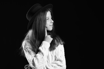 Black and white portrait of cute little girl on dark background