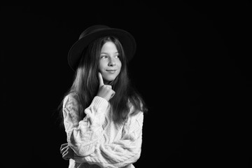 Fototapeta na wymiar Black and white portrait of cute little girl on dark background