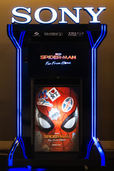 Obraz premium Bangkok, Thailand - Jun 24, 2019: Spider-Man: Far From Home poster and TV screen kiosk display showing movie trailer in theatre. Cinema promotional advertisement, or film industry marketing concept