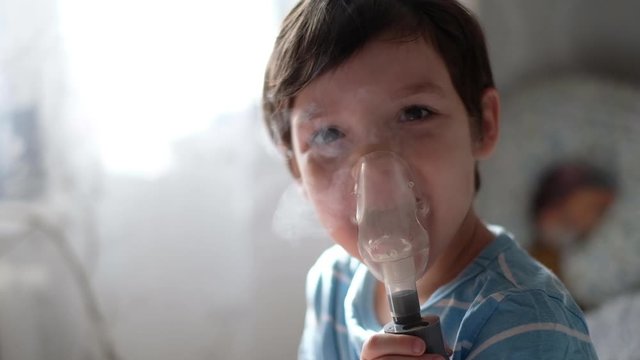 sick child breathes in a nebulizer