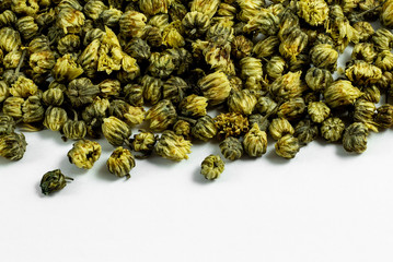 a group of dried chrysanthemum tea flowers on white background