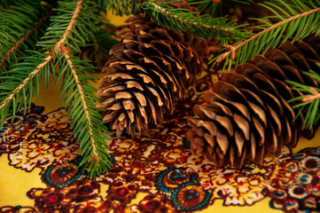 Naklejka na ściany i meble Fir tree with Pine cones. Christmas decoration background.