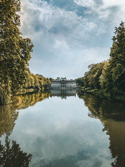Lake in Warsaw city park. Lake and palace in Lazienki park in Warsaw. Nature autumn landscape. Palace in the park. Royal Baths Park in Warsaw. Travel and tourism in Warsaw concept.