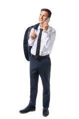 Portrait of handsome young businessman talking by phone on white background