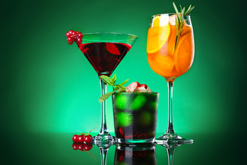 Different tasty cocktails on dark color background