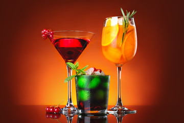 Different tasty cocktails on dark color background