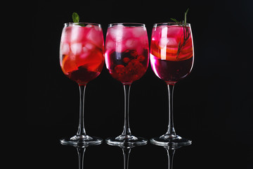 Different tasty cocktails on dark background