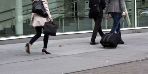 Businessmen and businesswoman walking to a trade fair