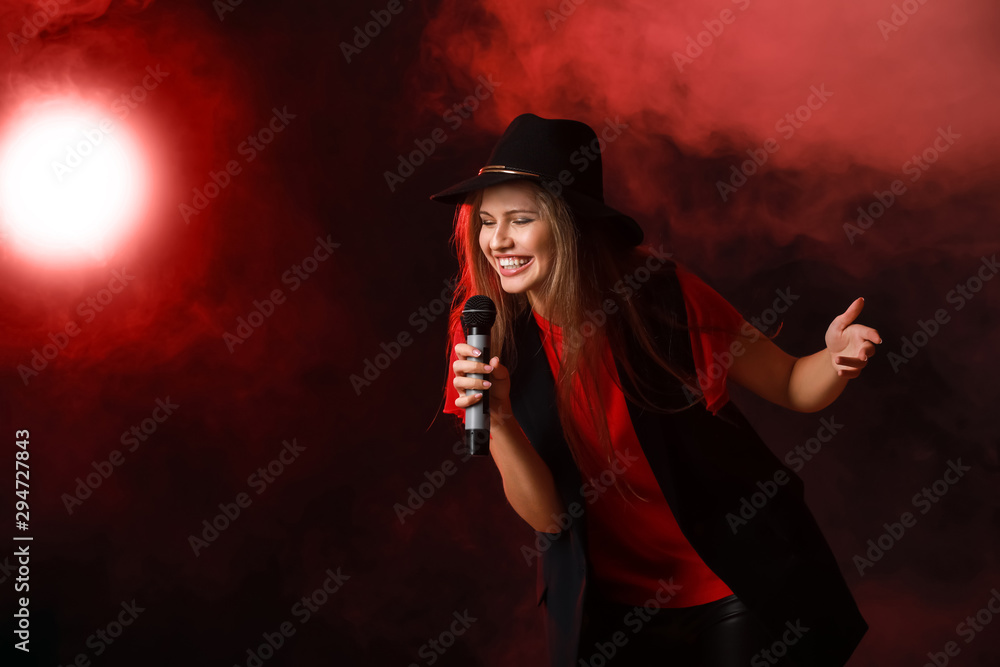 Sticker Beautiful young female singer with microphone on stage