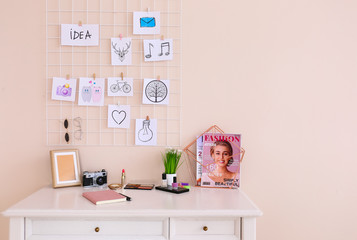 Comfortable workplace with mood board in room