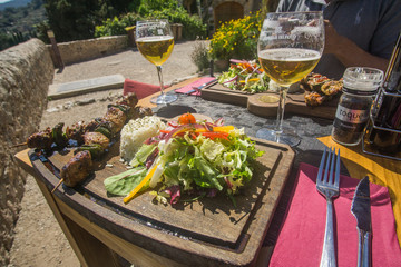 Beer and skewers on Lunch time in a restaurant that have a beautiful view of the valley and mountains at the village of Valldemossa in Palma de Mallorca Spain. 