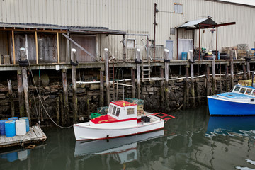 Fototapeta premium Commercial fishing wharf with stacks of lobster traps in the Old Port Harbor district of Portland, Maine. 