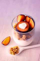 TOP VIEW OF GLASS GLASS WITH CEREAL DESSERT, GREEK YOGURT AND PLUMBERS