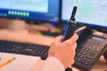 Security guard monitoring modern CCTV cameras in surveillance room. Female security guard in...