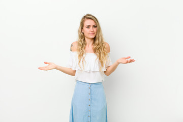 young blonde woman feeling puzzled and confused, unsure about the correct answer or decision,...