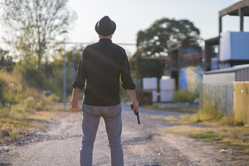 criminal with dark shirt, hat, and gun replica