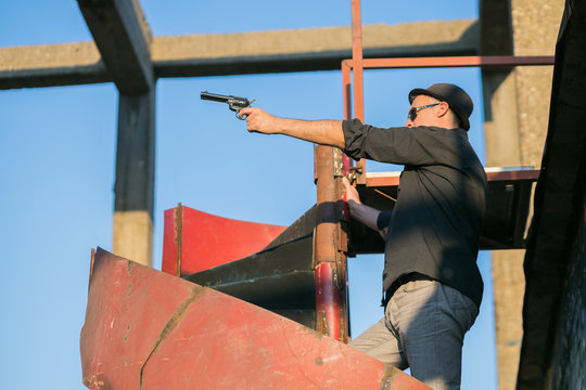 criminal with hat and gun replica dueling in gunfight
