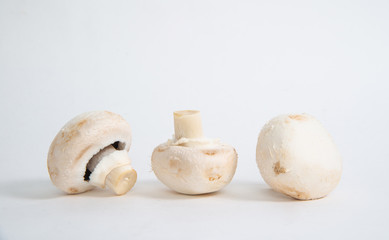 Champignons on white background. The concept of eating mushrooms. Adding mushrooms to dishes, improving the taste of champignons dishes.