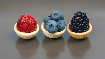 Blackberry, blueberry and strawberry in a waffle basket. Vitamins and wholesome foods