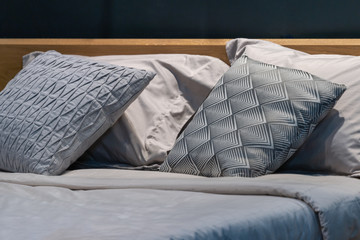 Modern gray fabric pillows and checkered pattern on the bed interior decoration