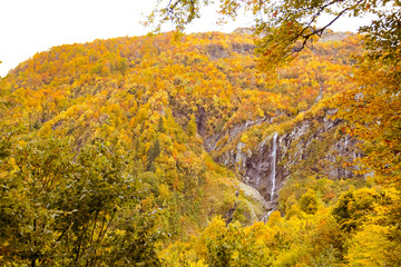 autumn sky with clouds, landscape of mountains and waterfall