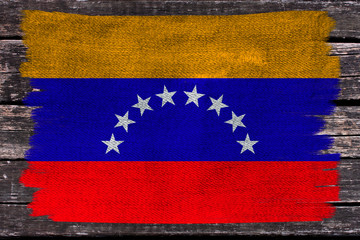 photo of the beautiful colored national flag of the modern state of Venezuela on textured fabric, concept of tourism, emigration, economics and politics, closeup