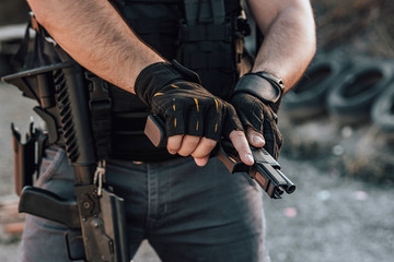 Close-up image of a mercenary with all kinds of weapon, close-up. - obrazy, fototapety, plakaty