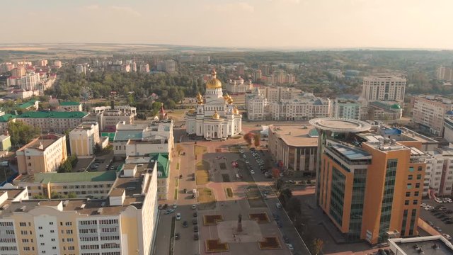 Aerial flying slow lowering down to the russian orthodox the Cathedral of St. Theodore Ushakov in Saransk, Russia. Taken by drone at sunset