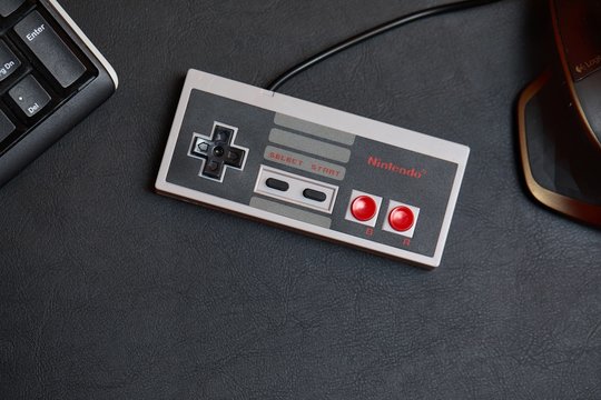 BUDAPEST, HUNGARY - FEBRUARY 17, 2018: Classic Nintendo NES console controller from the 80s on a desk