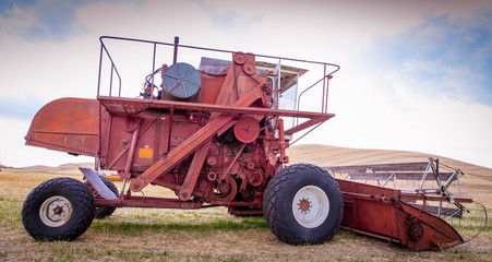 Antique red combine in palouse