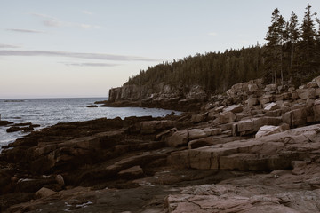 Rugged cliffs of Ocean Path along the shoreline of Acadia National Park in Mount Desert Island, Maine after sunset.