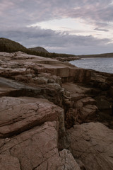 Fototapeta na wymiar Rugged cliffs of Ocean Path along the shoreline of Acadia National Park in Mount Desert Island, Maine after sunset.