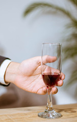 glass of red wine in hand
