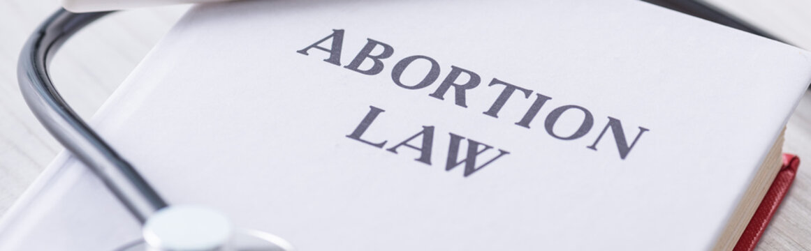 Panoramic Shot Of Book With Abortion Law Lettering Near Stethoscope