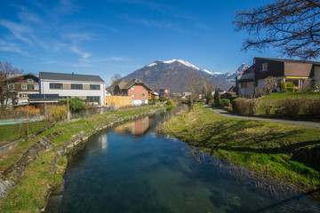 Fototapeta na wymiar Beautiful river and mountains view from a little village with the name Niederurnen in Switzerland. 