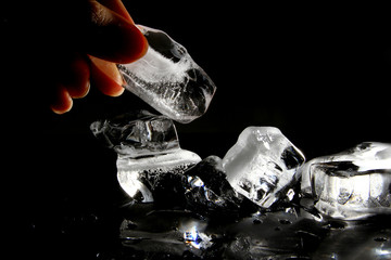 Melted ice block on black background
