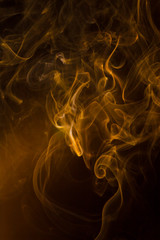 Obraz premium Gold smoke on black background.