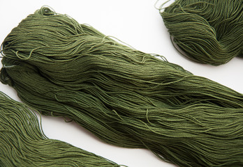 Closeup of fine gauge yarn olive green isolated