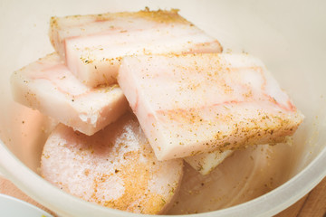 Raw fillet of mintai fish marinated in deep egg pan for cooking.