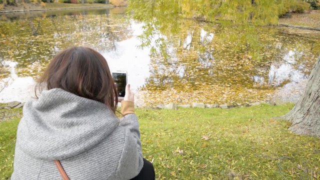 woman with mobile phone in park